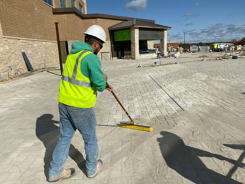 worker cleaning outdoor patio
