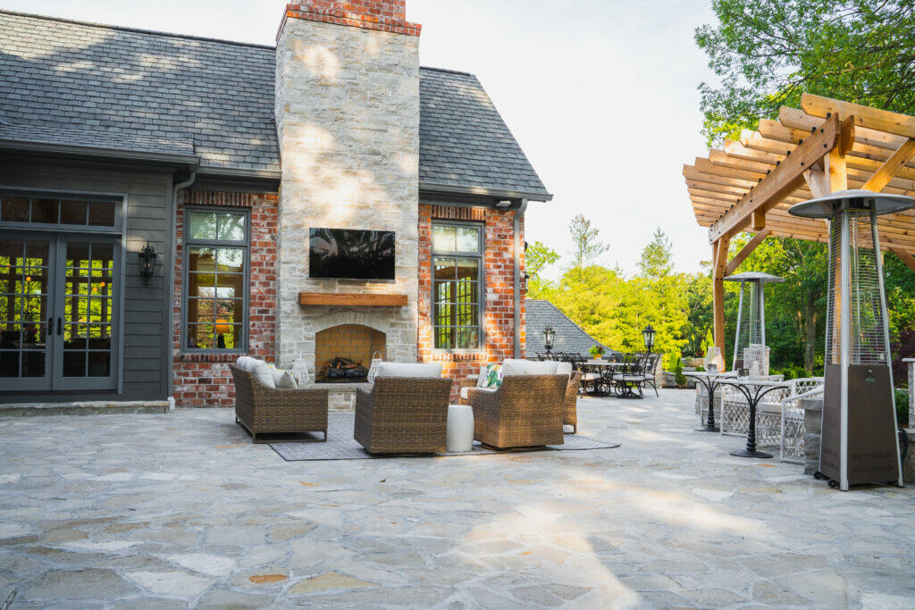 paver patio with fireplace built into house