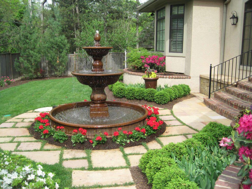 Water fountain featured in a yard.