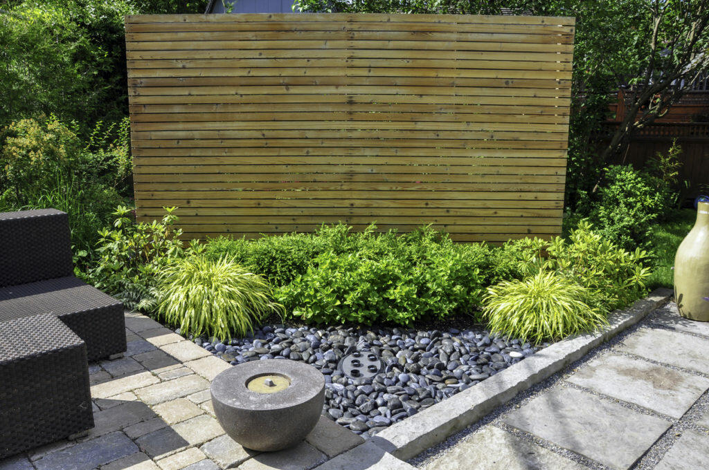 A small privacy fence in the garden is a great way to add a focal point.